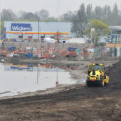 A compactor helps create a temporary access route across the site