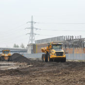 A truck moves earth around the site