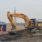 A digger clearing the top layer of earth