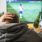 A supporter watches football on TV while holding a beer bottle